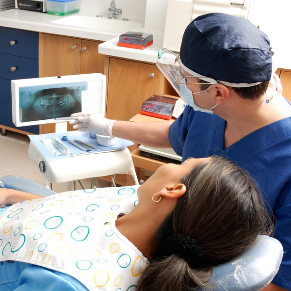 dentist showing patient x-ray